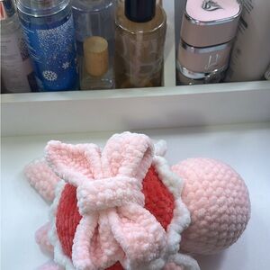 Baby pink, white, hot pink turtle with a bow on its back. Crocheted and handmade
